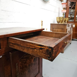 Stunning early 19th Century Elm buffet featuring two highly figured elm doors and drawers, it provides ample storage and is in good original condition.