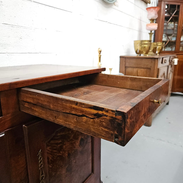 Stunning early 19th Century Elm buffet featuring two highly figured elm doors and drawers, it provides ample storage and is in good original condition.