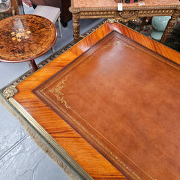 An exceptional French 19th Century Louis XV style "Bureau Plat" tooled leather top desk. Made from kingwood and rosewood, It has superb gilt cast ormolu mounts all the way around which means it can be used floating in the center of a room. In very good restored condition.