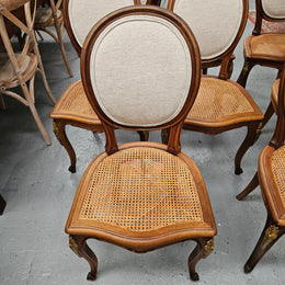 Stunning set of eight French Louis XV style walnut cane seat with upholstered back and ormolu mounts on the legs. Circa 1900. They are in excellent original condition and very comfortable. Please see photos as they form part of the description and condition.