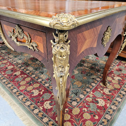 An exceptional French 19th Century Louis XV style "Bureau Plat" tooled leather top desk. Made from kingwood and rosewood, It has superb gilt cast ormolu mounts all the way around which means it can be used floating in the center of a room. In very good restored condition.