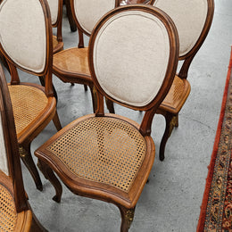 Stunning set of eight French Louis XV style walnut cane seat with upholstered back and ormolu mounts on the legs. Circa 1900. They are in excellent original condition and very comfortable. Please see photos as they form part of the description and condition.