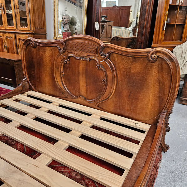 Beautifully carved Antique Louis XV style French Walnut queen size bed. Comes with custom made bed slates. Sourced from France and in good original detailed condition.