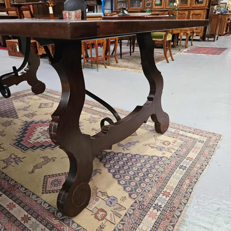 Vintage walnut Spanish style farmhouse table with a beautiful top and iron work. It is in good restored condition. Circa 1950'S.