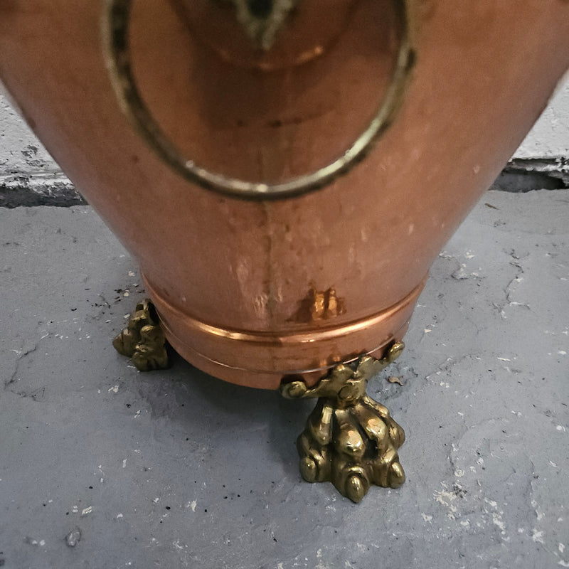 Lovely copper and brass pot with lions heads on the handles and lions feet on the base. It is in good original condition. 