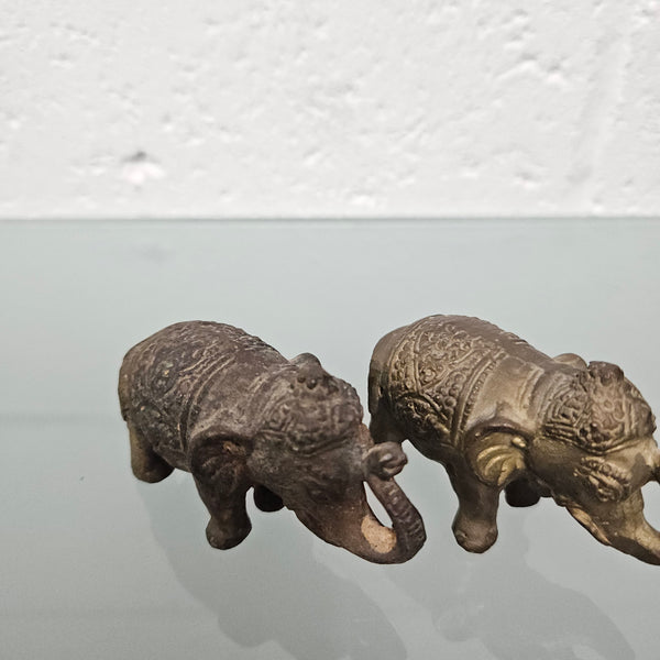 Pair of vintage aged brass elephants with raised trunks, in good original condition.