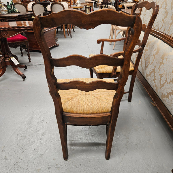 Set of ten French oak rush seats with eight dining chairs and two carvers. They have a comfortable wide rush seat and are in good original condition.