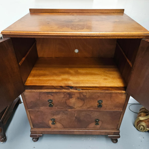 Lovely figured walnut Antique cabinet with a two door cabinet and two drawers. Circa 1930s. This cabinet can be used as a regular cabinet, drinks cabinet or tv unit as it has the hole for cables at the back. It is in good original detailed condition. 