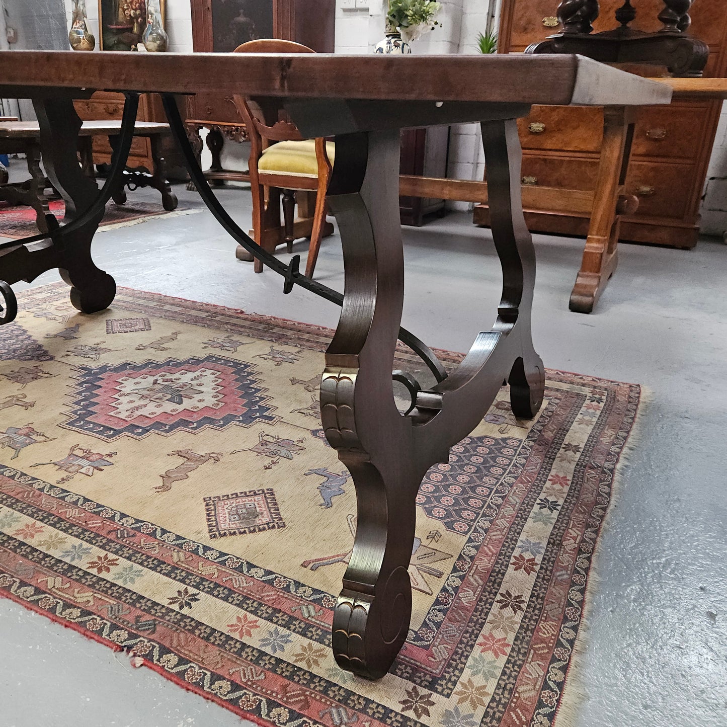 Vintage walnut Spanish style farmhouse table with a beautiful top and iron work. It is in good restored condition. Circa 1950'S.