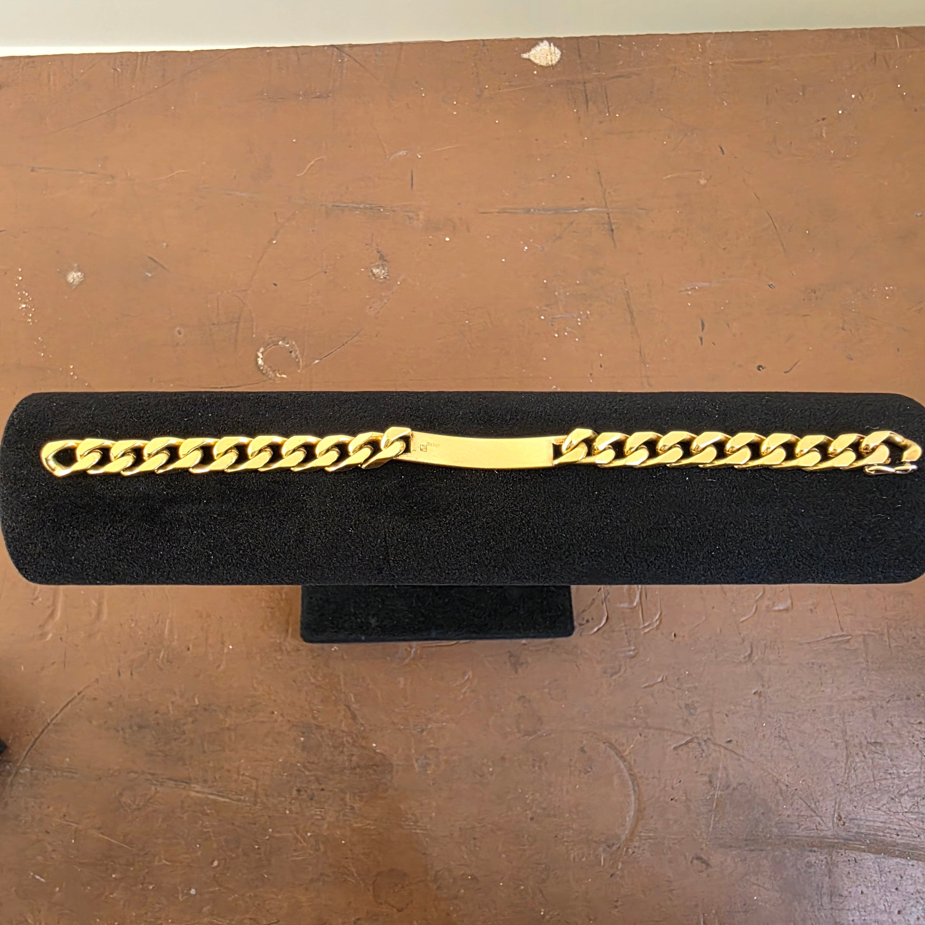 Overhead view of the vintage gold-tone Americ identity bracelet laid flat