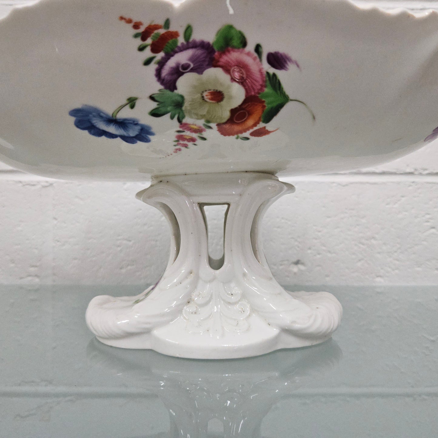 Lovely antique Coalport comport with a floral design 1830's , it is in good original condition with some faults under the bowl during the making. 