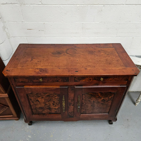 Stunning early 19th Century Elm buffet featuring two highly figured elm doors and drawers, it provides ample storage and is in good original condition.