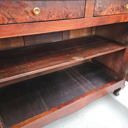 Stunning early 19th Century Elm buffet featuring two highly figured elm doors and drawers, it provides ample storage and is in good original condition.