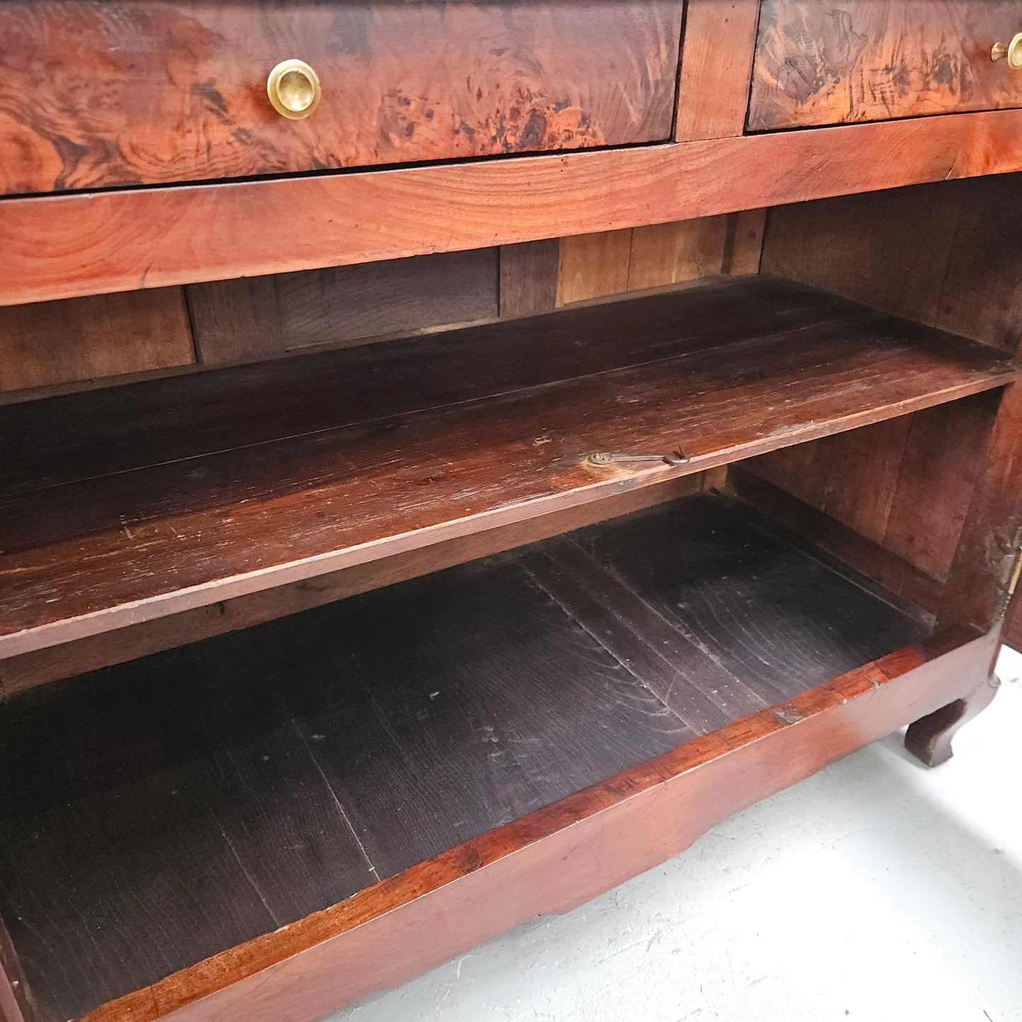 Stunning early 19th Century Elm buffet featuring two highly figured elm doors and drawers, it provides ample storage and is in good original condition.