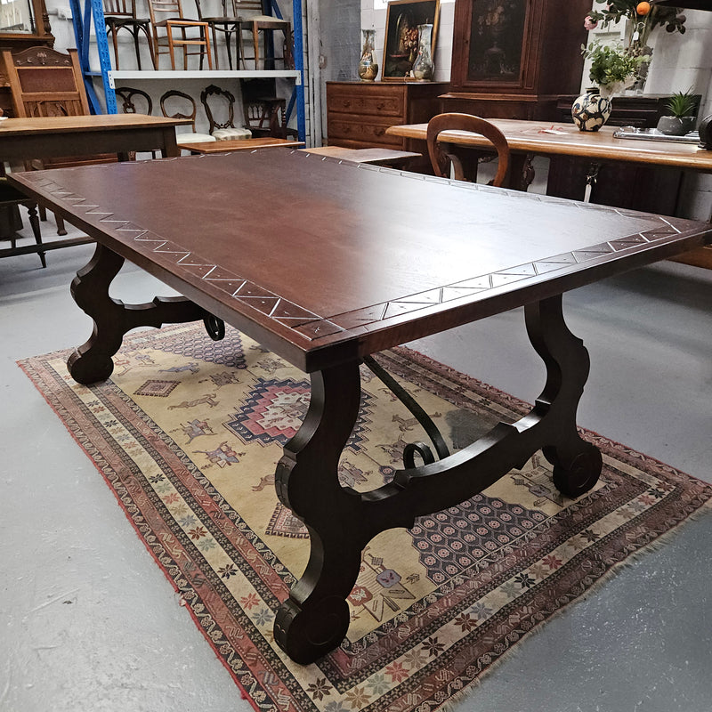 Vintage walnut Spanish style farmhouse table with a beautiful top and iron work. It is in good restored condition. Circa 1950'S.