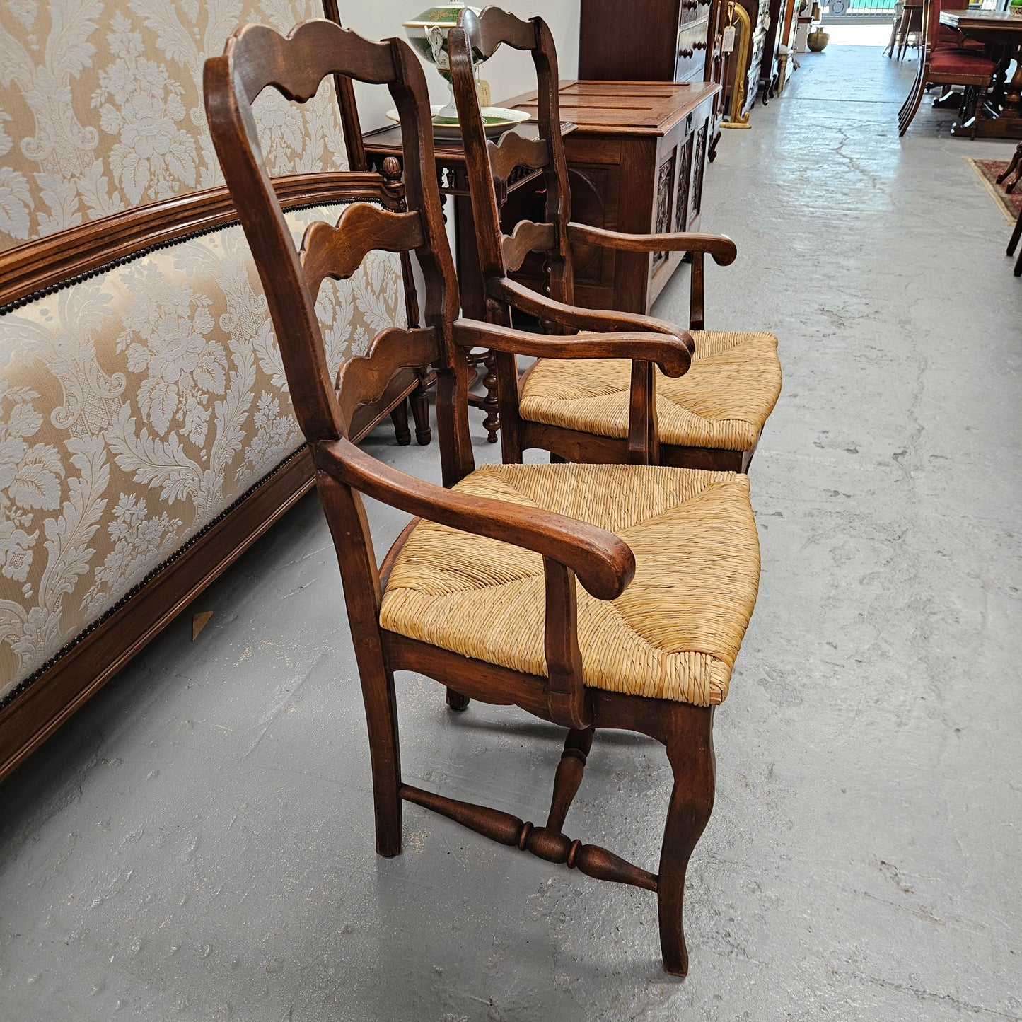 Set of ten French oak rush seats with eight dining chairs and two carvers. They have a comfortable wide rush seat and are in good original condition.