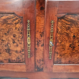 Stunning early 19th Century Elm buffet featuring two highly figured elm doors and drawers, it provides ample storage and is in good original condition.