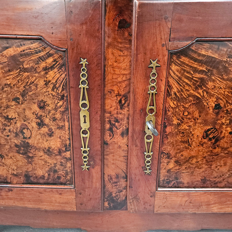 Stunning early 19th Century Elm buffet featuring two highly figured elm doors and drawers, it provides ample storage and is in good original condition.