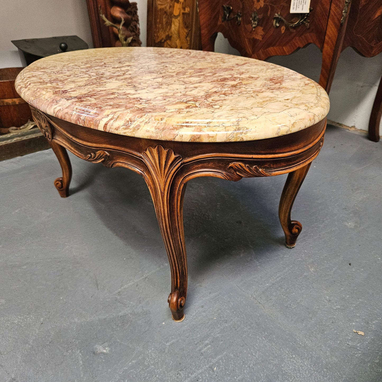 Lovely Louis XV style French fruitwood oval coffee table with a beautiful marble top. This piece is in great original condition and have been detailed to maintain its original condition.