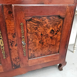 Stunning early 19th Century Elm buffet featuring two highly figured elm doors and drawers, it provides ample storage and is in good original condition.