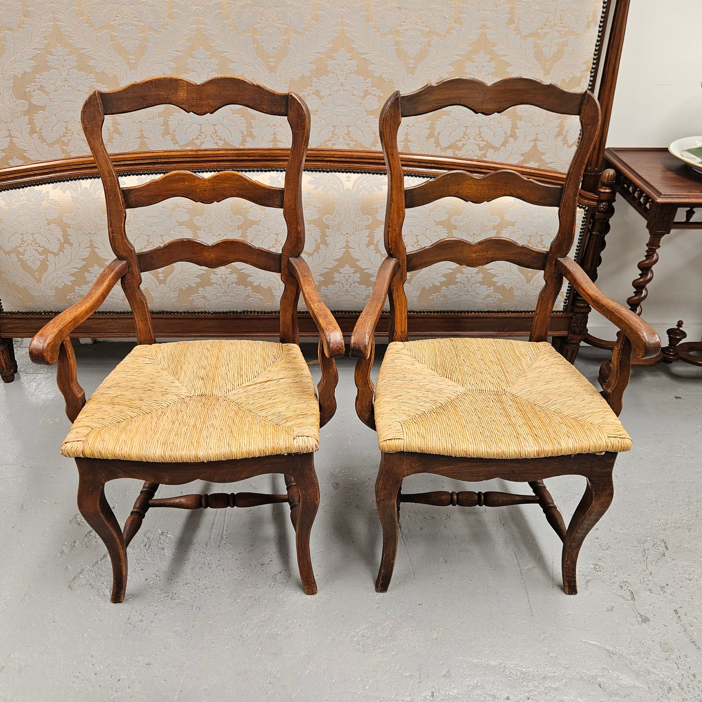 Set of ten French oak rush seats with eight dining chairs and two carvers. They have a comfortable wide rush seat and are in good original condition.