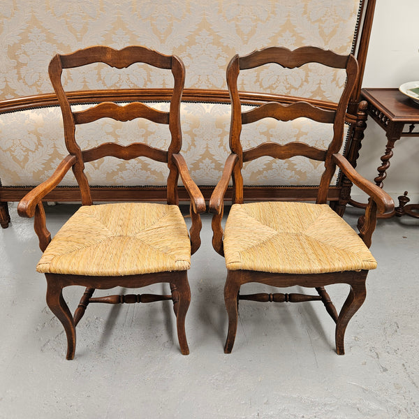 Set of ten French oak rush seats with eight dining chairs and two carvers. They have a comfortable wide rush seat and are in good original condition.