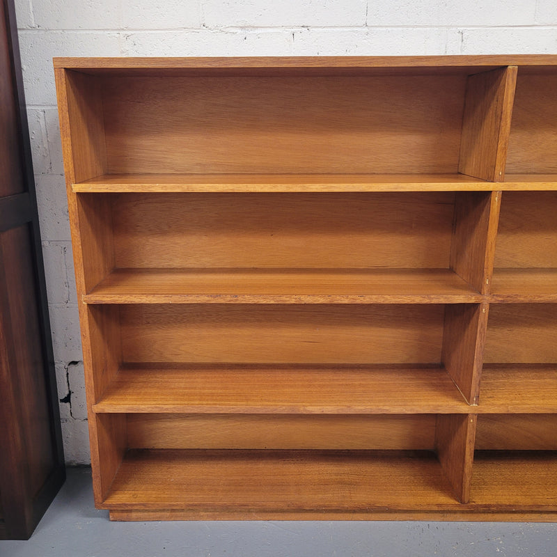 Australian Vic Ash double open bookcase with eight fixed shelves of pleasing narrow proportions. Sourced locally and in good original condition. Please view photos as they help form part of the description and condition.