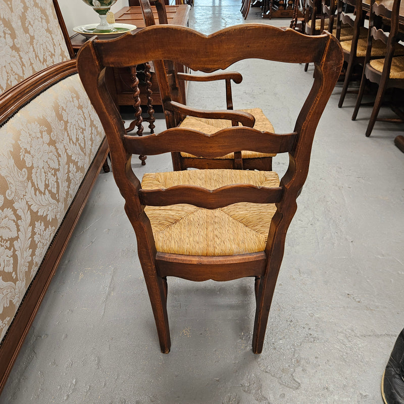 Set of ten French oak rush seats with eight dining chairs and two carvers. They have a comfortable wide rush seat and are in good original condition.