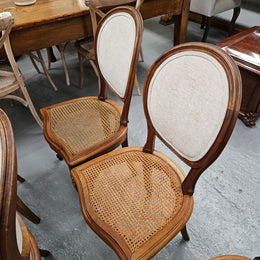 Stunning set of eight French Louis XV style walnut cane seat with upholstered back and ormolu mounts on the legs. Circa 1900. They are in excellent original condition and very comfortable. Please see photos as they form part of the description and condition.