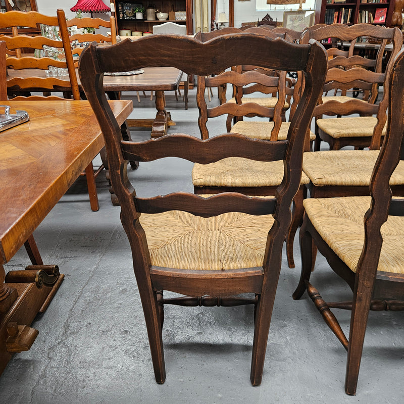 Set of ten French oak rush seats with eight dining chairs and two carvers. They have a comfortable wide rush seat and are in good original condition.