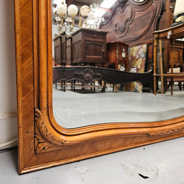 A fabulous tall Louis XV style Walnut floor/mantle mirror featuring decorative bronze gilt ormolu mounts. It still contains its beautiful original bevelled edged mirror. It has been sourced from France and is in good original detailed condition.
