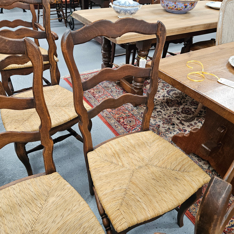 Set of ten French oak rush seats with eight dining chairs and two carvers. They have a comfortable wide rush seat and are in good original condition.