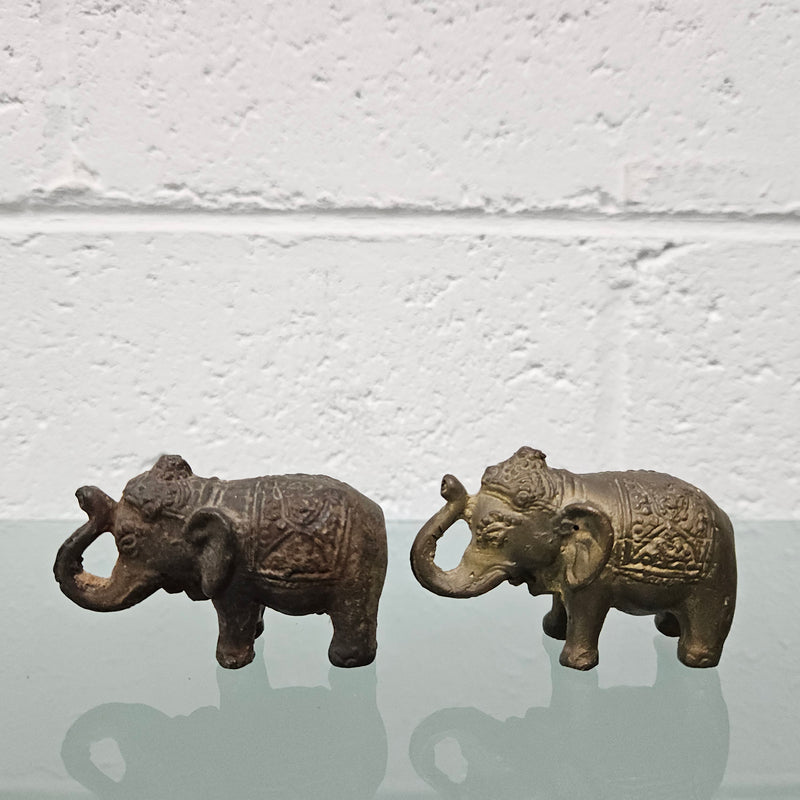 Pair of vintage aged brass elephants with raised trunks, in good original condition.