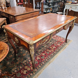 An exceptional French 19th Century Louis XV style "Bureau Plat" tooled leather top desk. Made from kingwood and rosewood, It has superb gilt cast ormolu mounts all the way around which means it can be used floating in the center of a room. In very good restored condition.