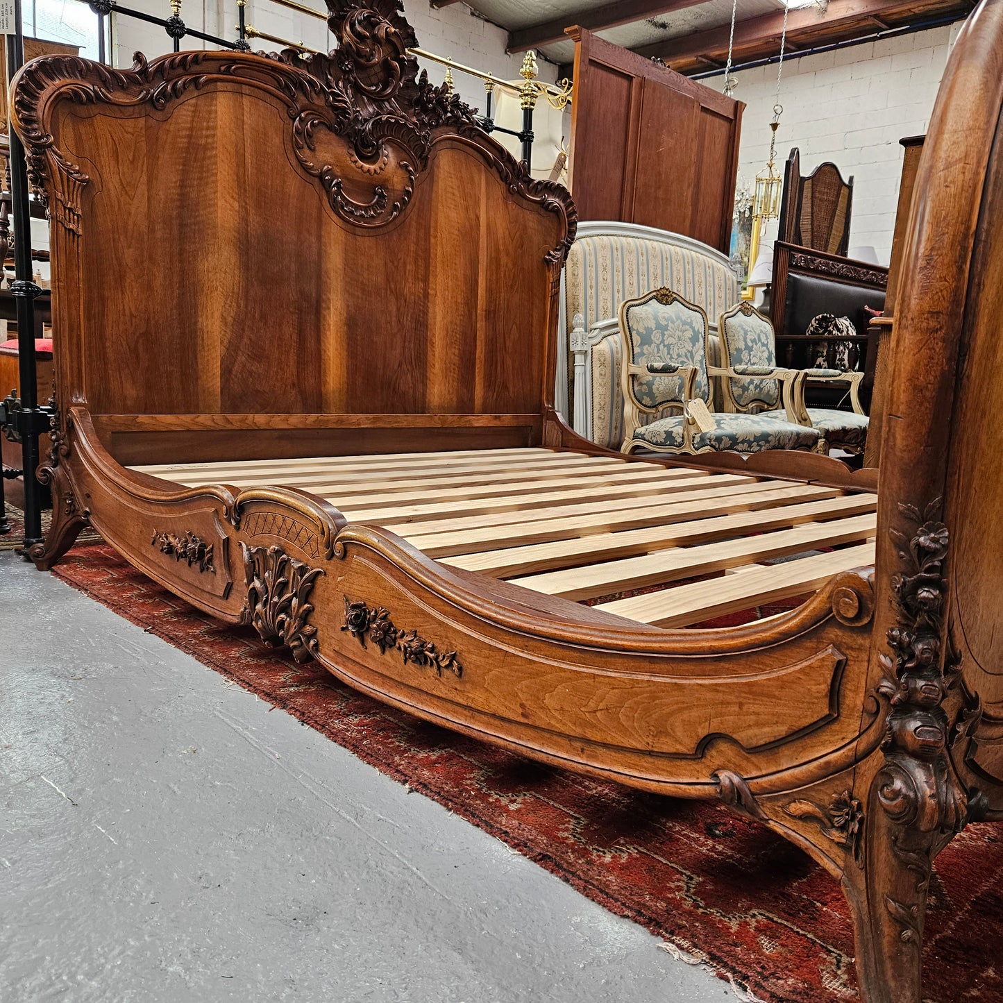 Beautifully carved Antique Louis XV style French Walnut queen size bed. Comes with custom made bed slates. Sourced from France and in good original detailed condition.