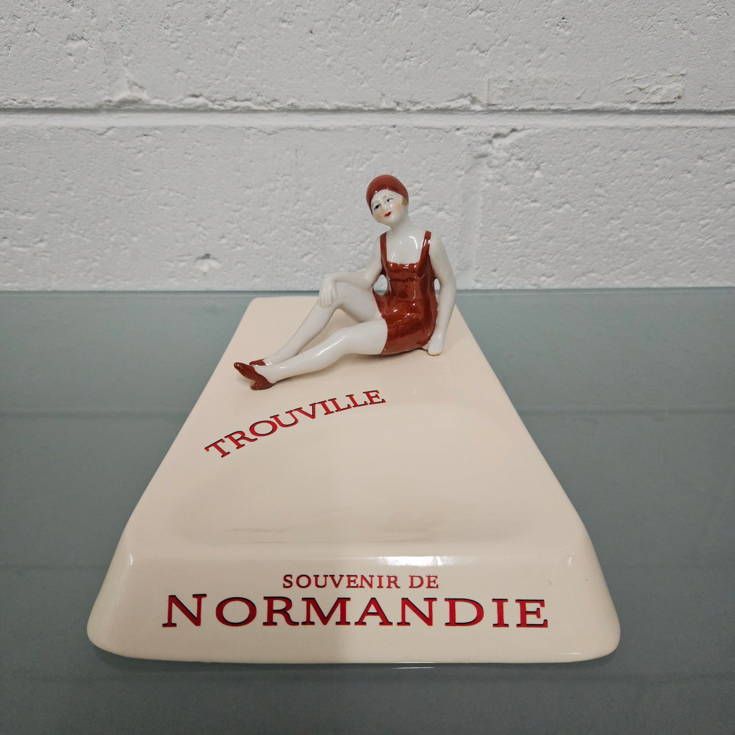 Unusual vintage female figure on large ceramic base. Souvenir Trouville De Normandie. Circa: 1950's.&nbsp; Could be used for keys, change or decoration. In good original condition.