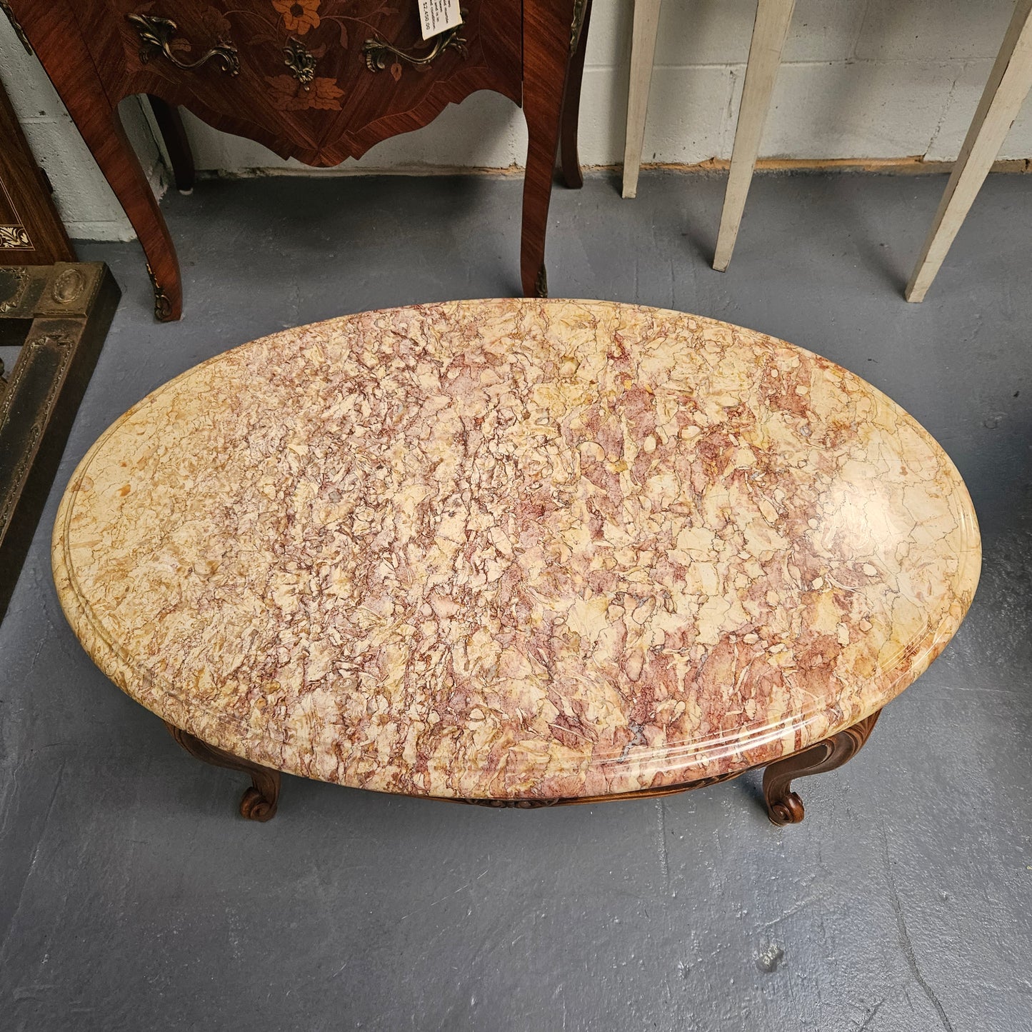 Lovely Louis XV style French fruitwood oval coffee table with a beautiful marble top. This piece is in great original condition and has been detailed to maintain its original condition.