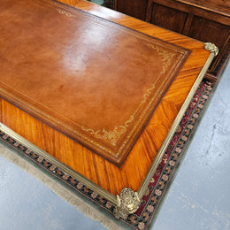 An exceptional French 19th Century Louis XV style "Bureau Plat" tooled leather top desk. Made from kingwood and rosewood, It has superb gilt cast ormolu mounts all the way around which means it can be used floating in the center of a room. In very good restored condition.