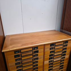 Timber top of a vintage 40-drawer glazed specimen collector’s cabinet