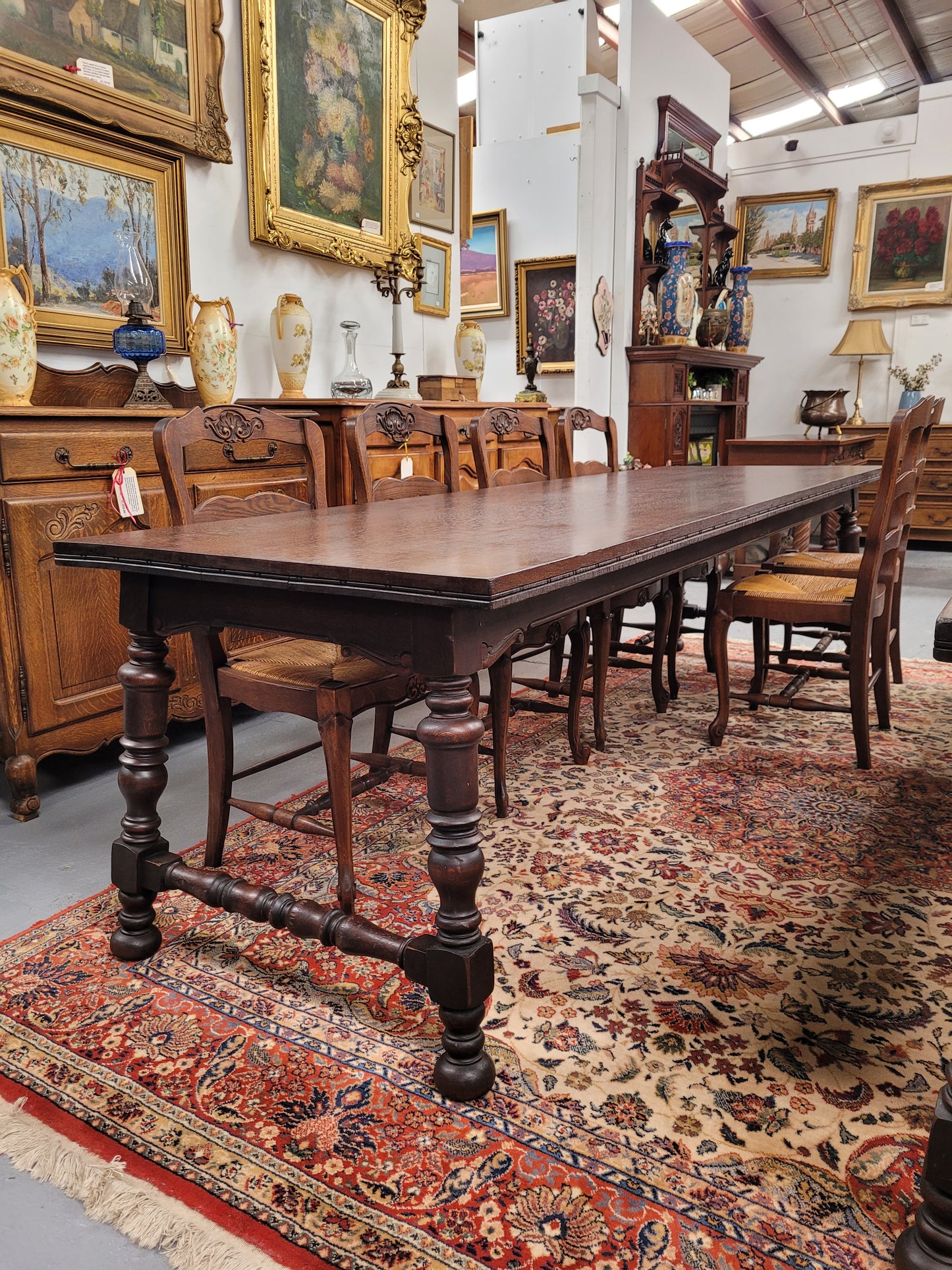 An Australian Silky Oak Spanish style refectory dining table measuring 274.5 cm in length. It can comfortable sit 8-10 people and is a very hard to find size. It is in good original detailed condition.