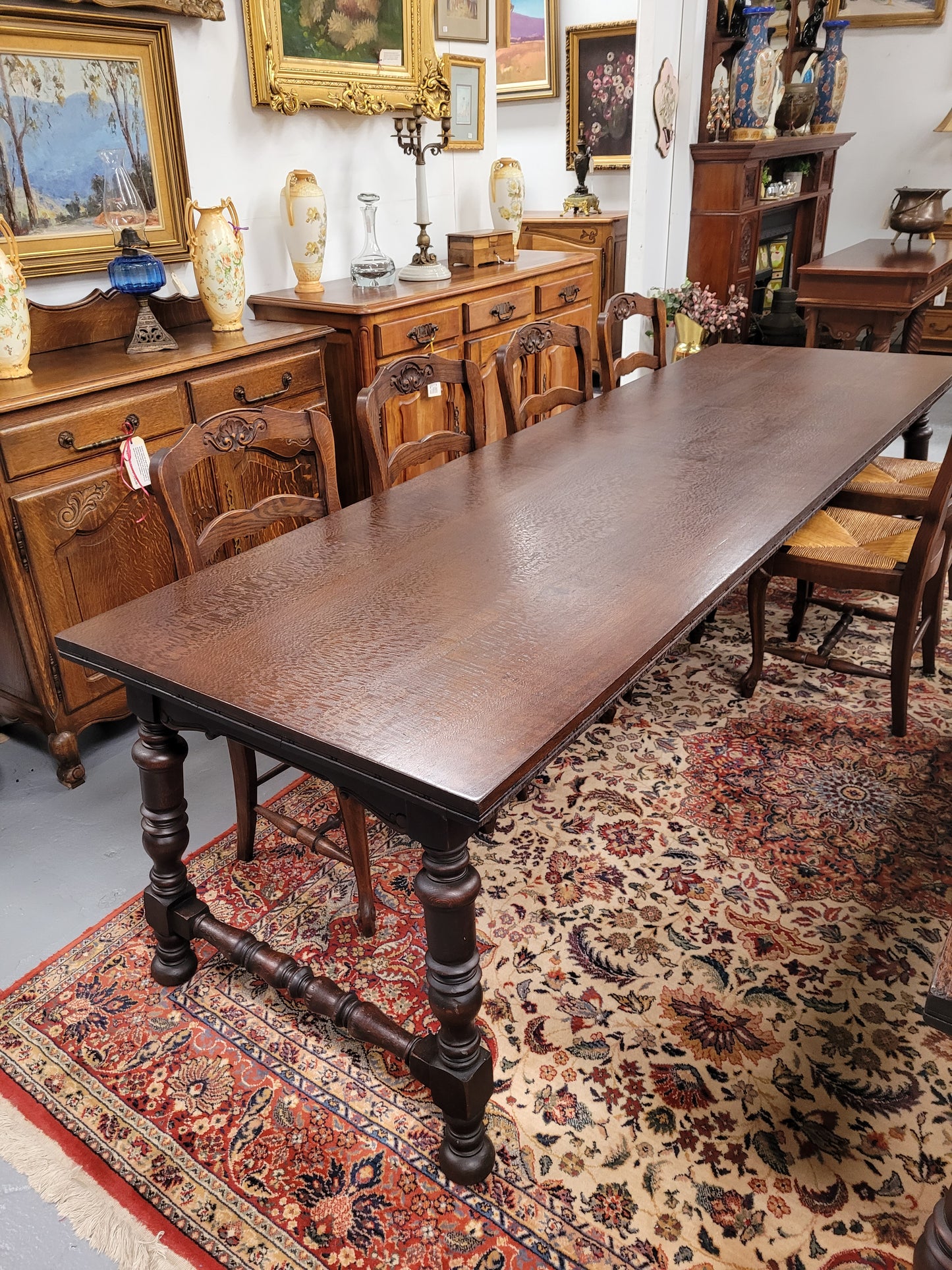 An Australian Silky Oak Spanish style refectory dining table measuring 274.5 cm in length. It can comfortable sit 8-10 people and is a very hard to find size. It is in good original detailed condition.