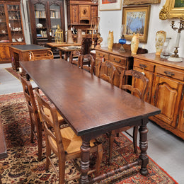 An Australian Silky Oak Spanish style refectory dining table measuring 274.5 cm in length. It can comfortable sit 8-10 people and is a very hard to find size. It is in good original detailed condition.