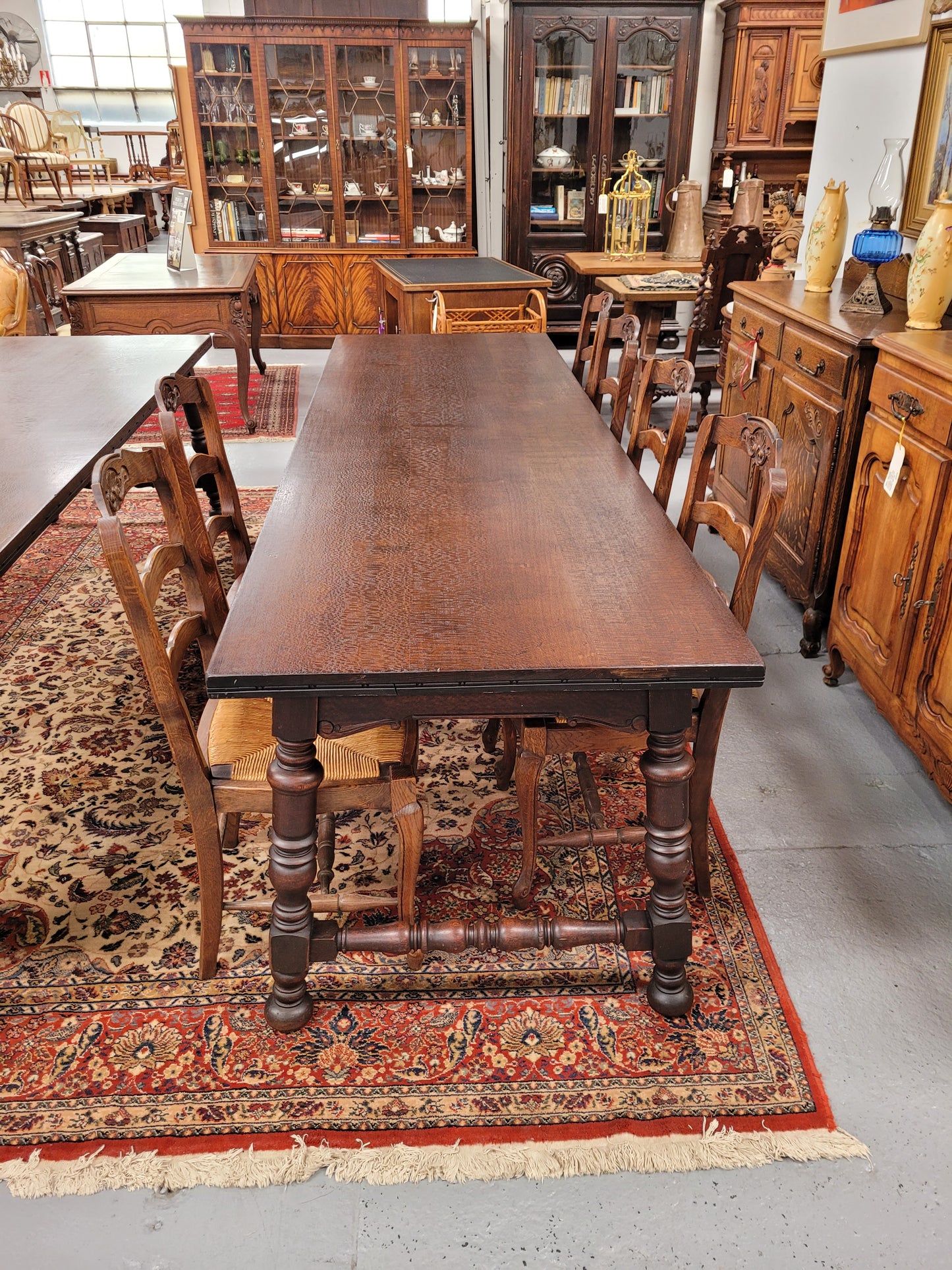 An Australian Silky Oak Spanish style refectory dining table measuring 274.5 cm in length. It can comfortable sit 8-10 people and is a very hard to find size. It is in good original detailed condition.