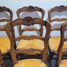A set of 6 French Louis XV style oak dining chairs with rush seats in good original condition. All chairs have been detailed and re-glued where needed.