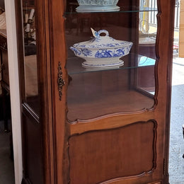 Petite French Louis XV style Walnut display cabinet with two glass shelves that can be adjusted and added storage at the bottom . In very good original detailed condition.