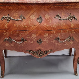 Stunning Louis XV style marquetry inlay marble top two drawer commode. It has decorative ormolu mounts and beautiful marble top. In good original detailed condition.