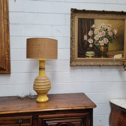 A large and impressive Vintage Mid-Century Bitossi Italian terra cotta lamp base and shade. Incised repeating geometric terra cotta pattern creates a tactile element which is incorporated with stunning shining thick yellow glaze to create the sculptural form of the base.