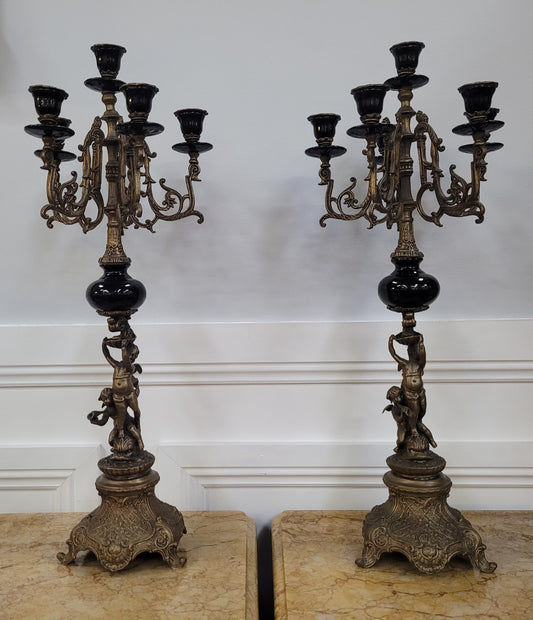 Vintage pair of decorative candlesticks featuring cherubs. They have been sourced locally and are in good original detailed condition.