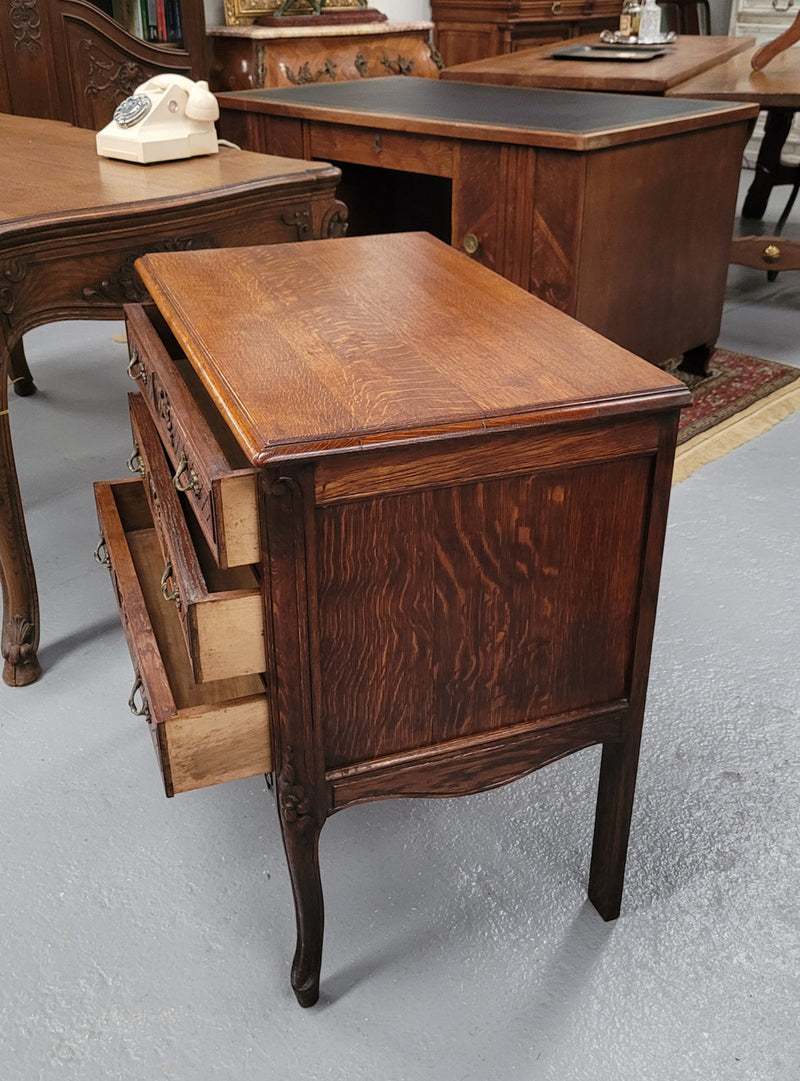 Rustic Louis XV style Oak petite three drawer chest featuring attractive carvings. It has been sourced locally and it is in good original detailed condition.