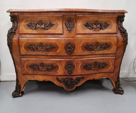 Sensational Grand French Walnut Bombe Commode with beautiful marquetry inlay. It has lovely decorative hardware and an amazing marble top in good original detailed condition.